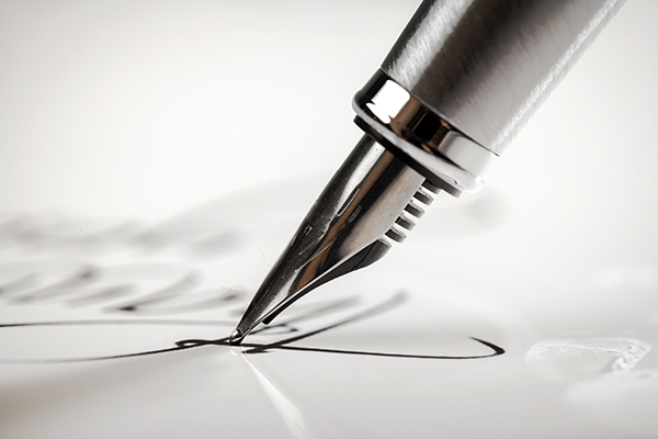 Fountain pen signing a letter