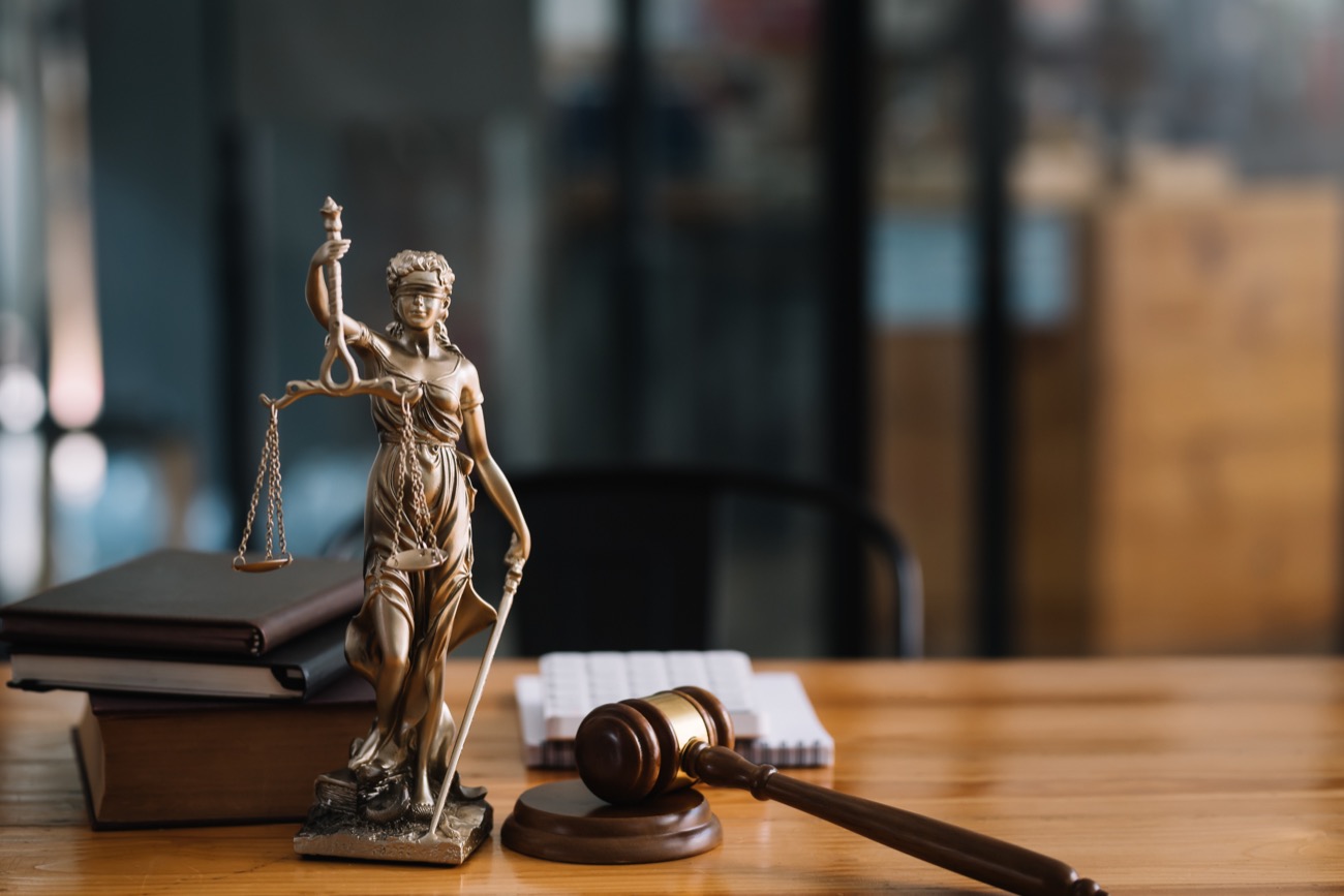 Lady Justice statue and gavel on an attorney's desk